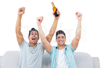 Happy football fans cheering together with beers Happy football fans cheering together with beers