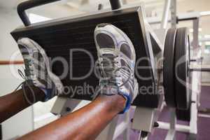 Weightlifter doing leg presses in gym