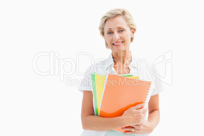 Happy mature student holding notebooks