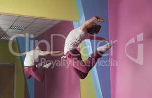 Cool break dancer mid air in front of mirror