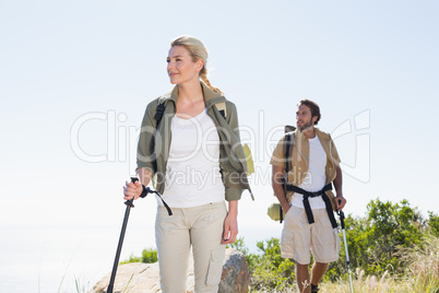 Attractvie hiking couple walking on mountain trail