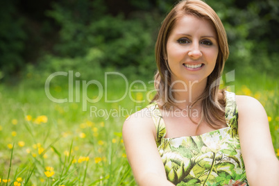 Cute young woman relaxing in field