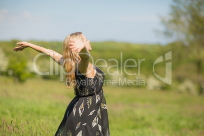 Pretty blonde in sundress standing with arms out Pretty blonde in sundress standing with arms out