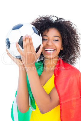 Pretty football fan with portugal flag holding ball