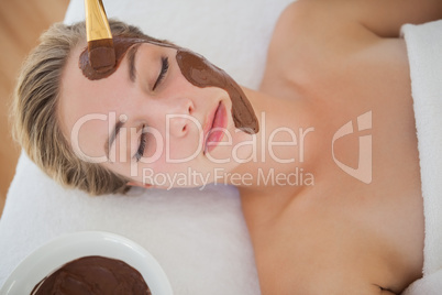 Beautiful blonde getting a chocolate facial treatment