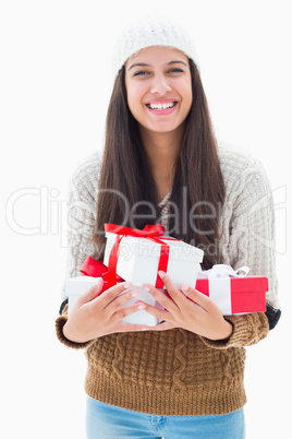 Pretty brunette holding many presents