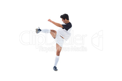 Football player in white kicking