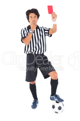 Stern referee showing red card