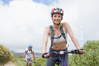 Fit couple cycling on mountain trail