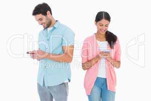 Happy couple sending text messages