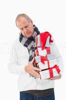 Mature man in winter clothes holding gifts