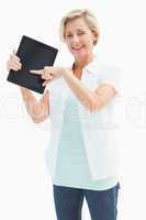 Happy mature woman pointing to tablet pc