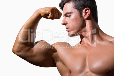 Close-up of a shirtless muscular man flexing muscles