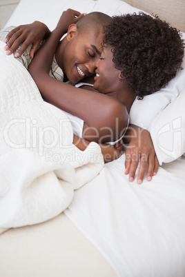 Happy couple in bed together