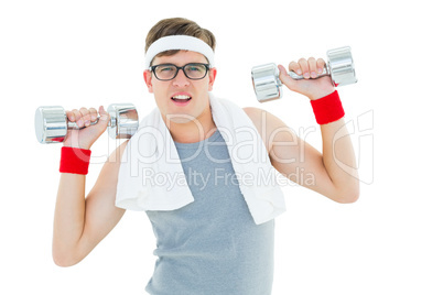 Geeky hipster lifting heavy dumbbells