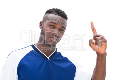 Football player in blue pointing up