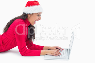 Beautiful festive woman typing on laptop