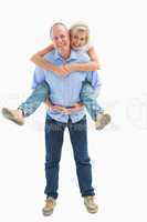 Mature man carrying his partner on his back