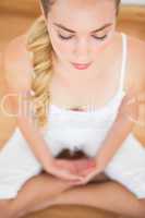 Peaceful blonde sitting in lotus pose