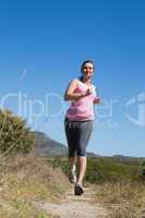 Active woman jogging in the countryside
