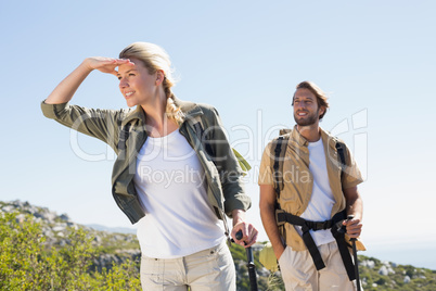 Attractive hiking couple walking on mountain trail