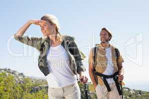 Attractive hiking couple walking on mountain trail