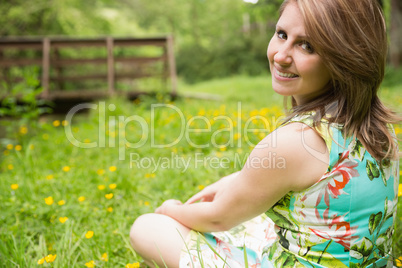 Cute young woman relaxing in field