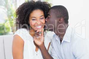 Attractive man kissing his girlfriend on the cheek