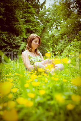 Thoughtful woman relaxing in field