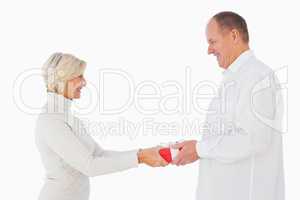 Blonde woman passing gift to her partner