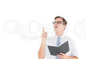Geeky businessman reading from book