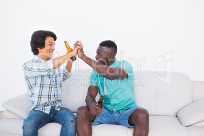 Football fans cheering and holding beer bottles