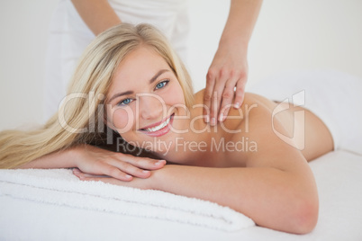 Pretty blonde enjoying a massage smiling at camera Pretty blonde enjoying a massage smiling at camera