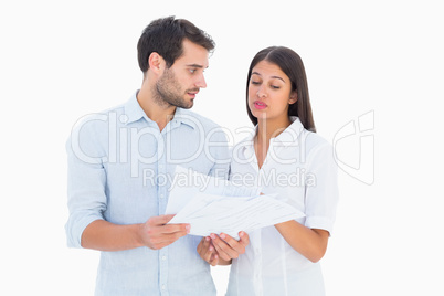 Attractive young couple reading their bills