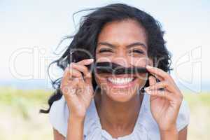 Funny woman making mustache with her hair