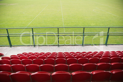 Red bleachers looking down on football pitch