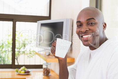 Happy man in bathrobe drinking coffee Happy man in bathrobe drinking coffee