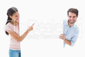 Attractive young couple smiling and holding poster