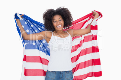 Pretty girl holding american flag cheering at camera