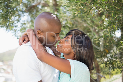 Happy couple hugging each other in garden