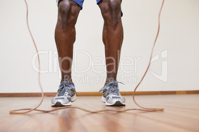 Muscular man skipping in gym