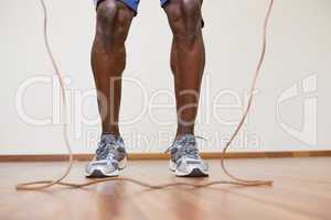 Muscular man skipping in gym