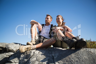 Hiking couple looking out over mountain terrain