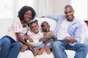 Happy family watching television together