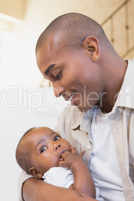 Happy father spending time with baby on the couch