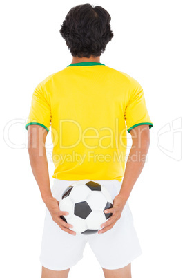 Football player in yellow holding ball