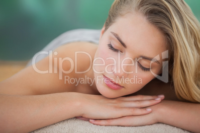 Peaceful blonde lying on towel