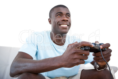Casual man smiling and playing video games