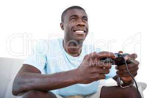 Casual man smiling and playing video games