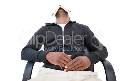 Man sleeping in swivel chair with book over face